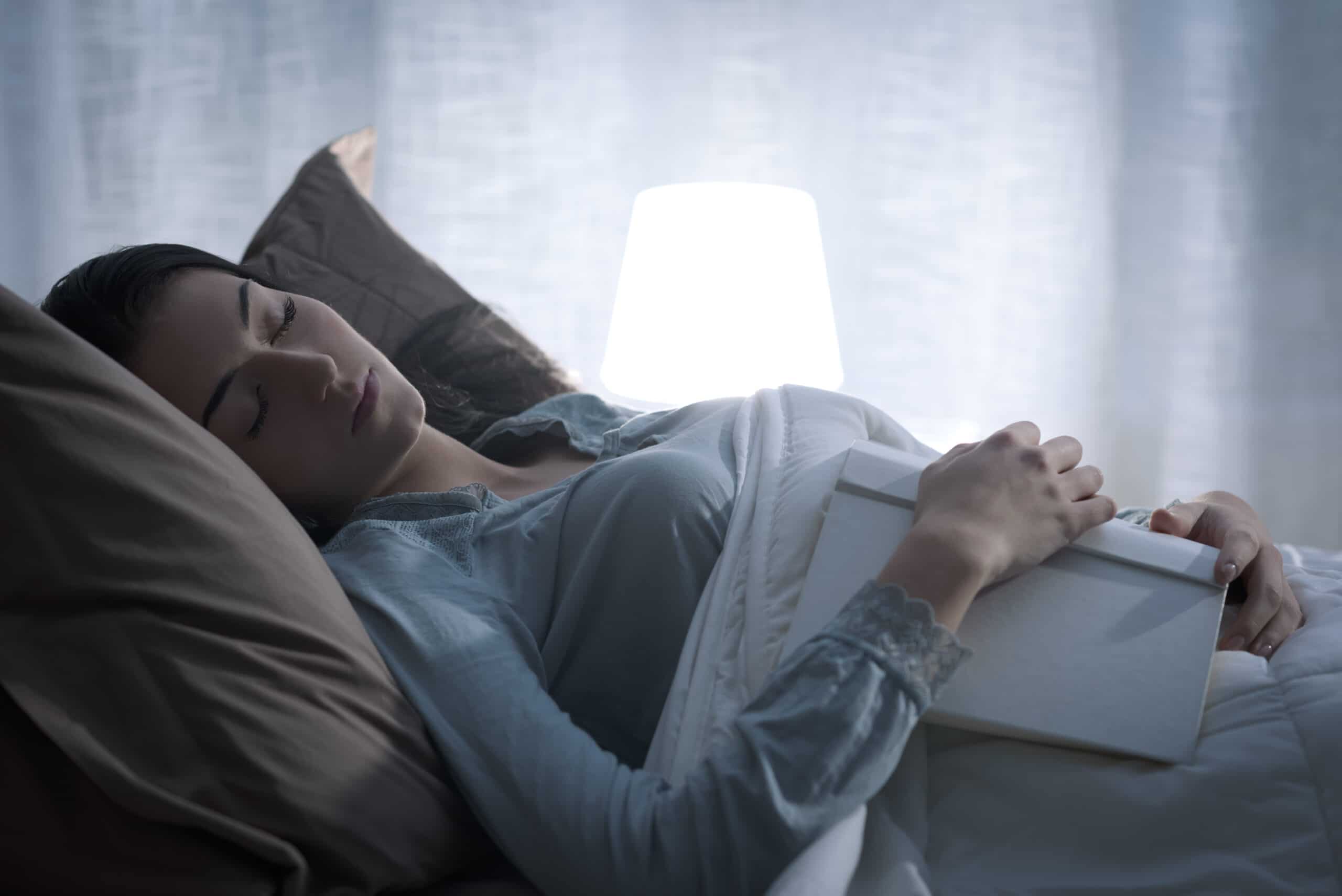 Woman falling asleep while reading a book